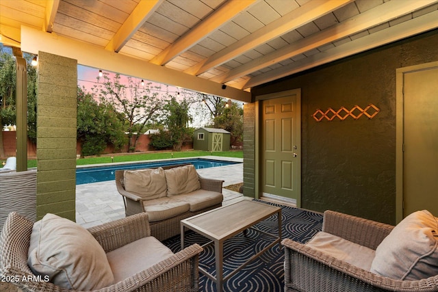 7813 N 17th Dr, Phoenix, AZ 85021 - patio terrace at dusk with an outbuilding, a shed, a fenced in pool, and a fenced backyard