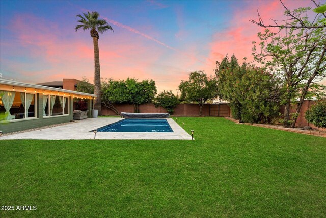 7813 N 17th Dr, Phoenix, AZ 85021 - pool at dusk featuring a lawn, a fenced backyard, a fenced in pool, and a patio area