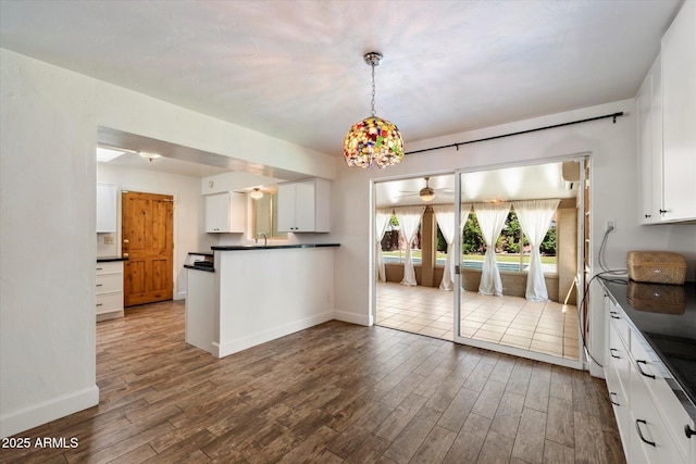 7813 N 17th Dr, Phoenix, AZ 85021 - kitchen featuring baseboards, dark countertops, white cabinets, and dark wood-type flooring