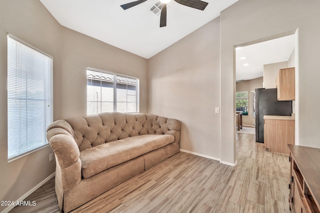 living room featuring light wood-type flooring, a healthy amount of sunlight, and ceiling fan