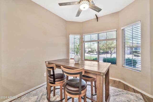 dining area featuring hardwood / wood-style flooring, a wealth of natural light, and ceiling fan