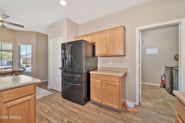 kitchen featuring ceiling fan, washing machine and clothes dryer, light hardwood / wood-style flooring, stainless steel refrigerator with ice dispenser, and light brown cabinetry