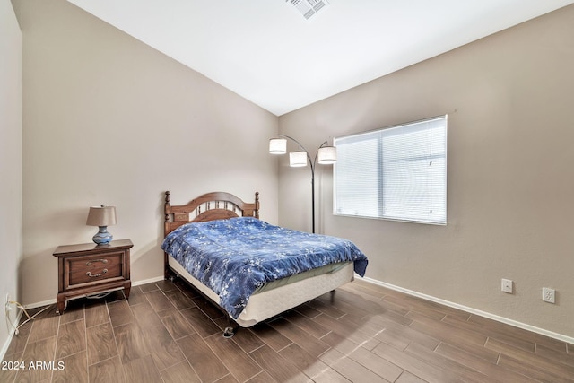 bedroom featuring dark hardwood / wood-style floors and vaulted ceiling