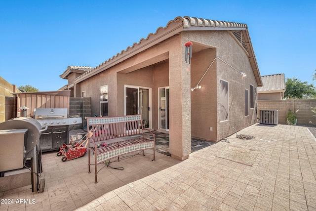 view of patio with cooling unit and grilling area