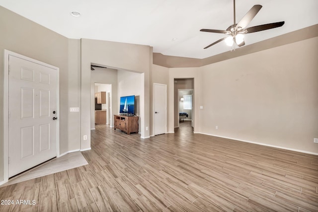 unfurnished living room with ceiling fan, light hardwood / wood-style floors, and high vaulted ceiling