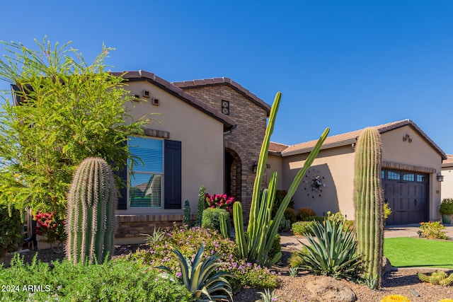 mediterranean / spanish-style home with a garage