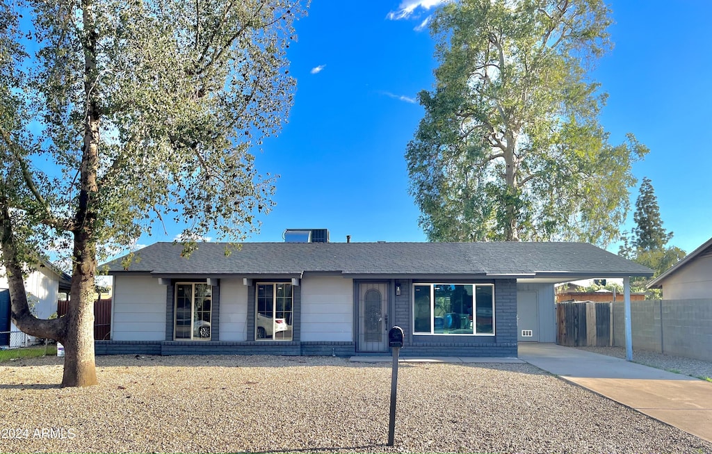 single story home featuring a carport