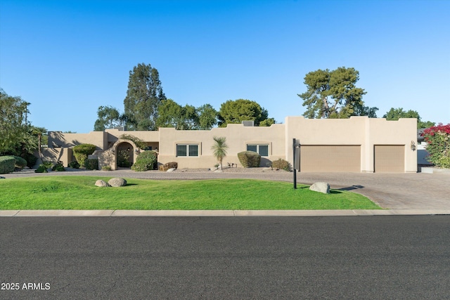 adobe home featuring a front yard