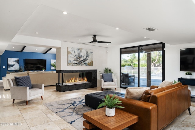 living room featuring ceiling fan, beam ceiling, light tile patterned flooring, and a fireplace