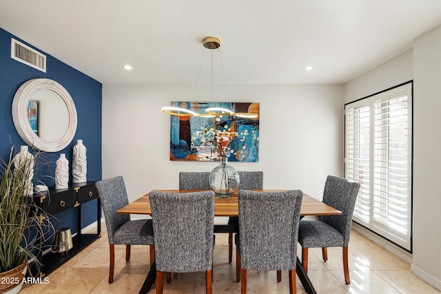 dining room featuring tile patterned flooring, a wealth of natural light, and an inviting chandelier