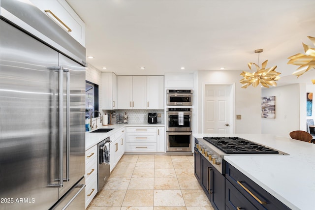 kitchen with decorative backsplash, stainless steel appliances, sink, white cabinetry, and light tile patterned flooring