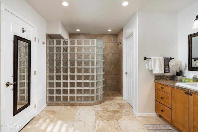 bathroom featuring vanity and tiled shower