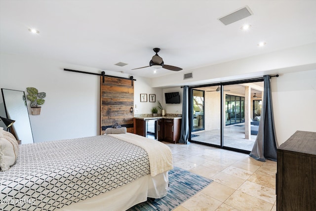 bedroom featuring access to exterior, a barn door, and ceiling fan