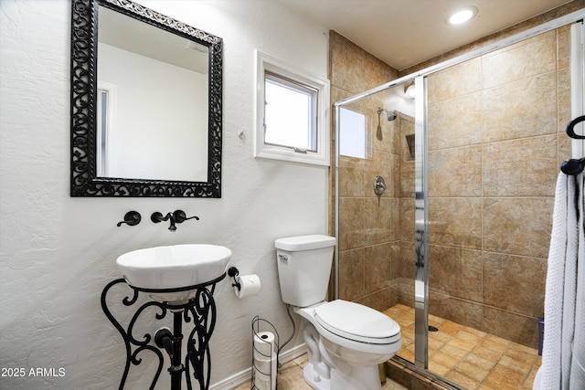 bathroom with an enclosed shower and toilet