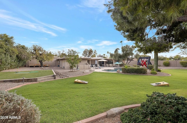 view of yard with a fenced in pool, a patio area, and a playground