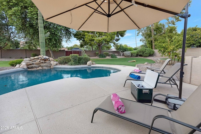 view of swimming pool with a lawn and a patio