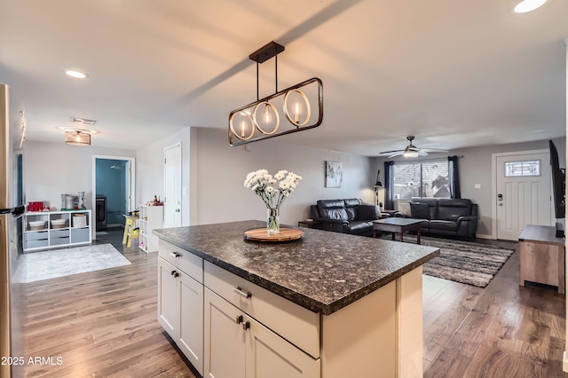 1718 W Voltaire Ave, Phoenix, AZ 85029 - kitchen with light wood-type flooring, dark countertops, ceiling fan, a center island, and recessed lighting