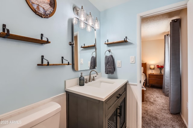 1718 W Voltaire Ave, Phoenix, AZ 85029 - ensuite bathroom featuring vanity, toilet, and wainscoting