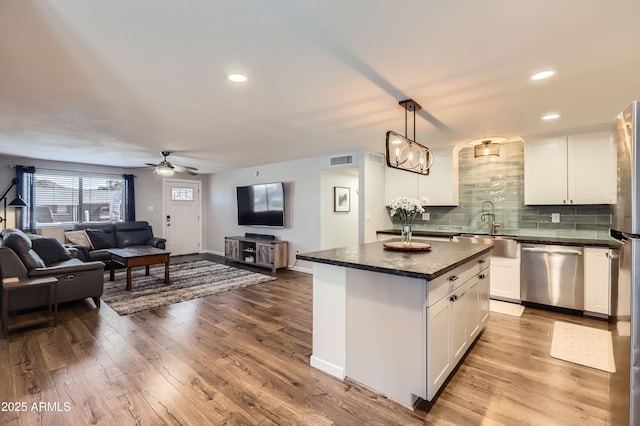 1718 W Voltaire Ave, Phoenix, AZ 85029 - kitchen featuring dishwasher, dark countertops, a sink, ceiling fan, and white cabinets
