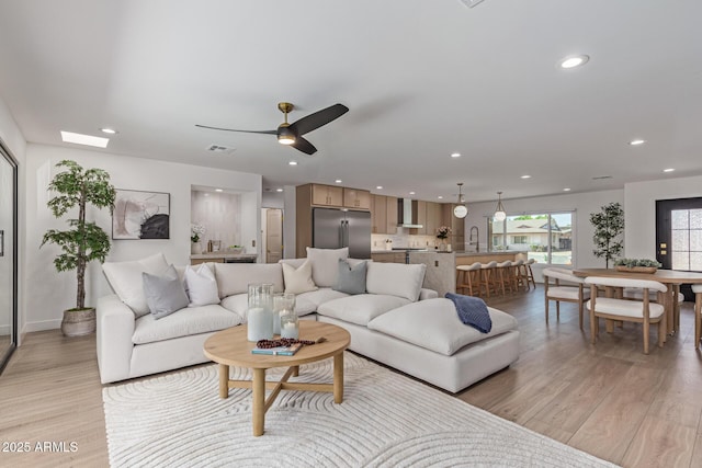 8119 E San Miguel Ave, Scottsdale, AZ 85250 - living room with light wood-style flooring, recessed lighting, and ceiling fan
