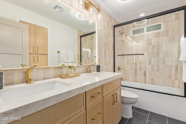 8119 E San Miguel Ave, Scottsdale, AZ 85250 - bathroom with double vanity, tile patterned flooring, and bath / shower combo with glass door