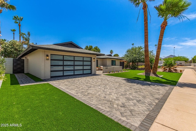 8119 E San Miguel Ave, Scottsdale, AZ 85250 - view of front of property with an attached garage, decorative driveway, and stucco siding