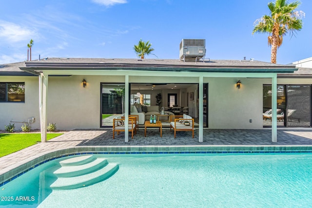 8119 E San Miguel Ave, Scottsdale, AZ 85250 - back of property featuring stucco siding, outdoor lounge area, a patio, and an outdoor pool