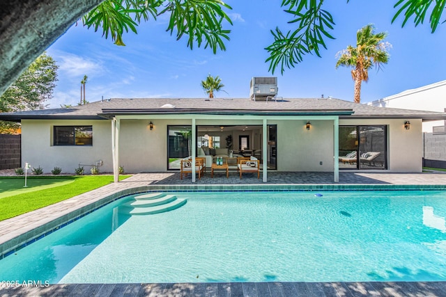 8119 E San Miguel Ave, Scottsdale, AZ 85250 - outdoor pool featuring an area to practice putting, a patio, and an outdoor living space