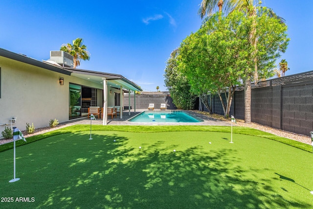 8119 E San Miguel Ave, Scottsdale, AZ 85250 - view of pool featuring a putting area, a patio area, and a fenced backyard