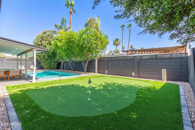 8119 E San Miguel Ave, Scottsdale, AZ 85250 - fenced backyard with an area to practice putting and a patio area
