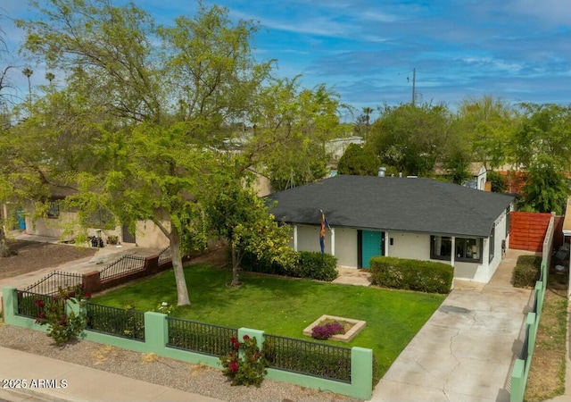 ranch-style house featuring a front yard, a fenced front yard, and stucco siding