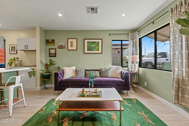 living area featuring recessed lighting, visible vents, baseboards, and light wood-style flooring