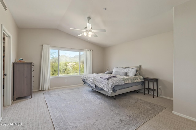 carpeted bedroom with baseboards, ceiling fan, and vaulted ceiling