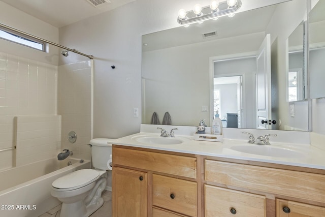 bathroom with washtub / shower combination, double vanity, toilet, and a sink