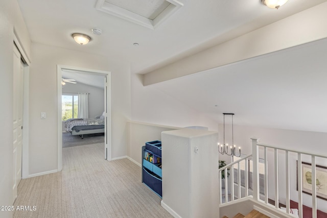 hallway with baseboards and carpet flooring