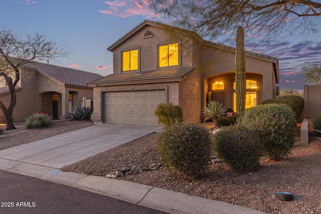 mediterranean / spanish house with a tile roof, concrete driveway, a chimney, stucco siding, and a garage