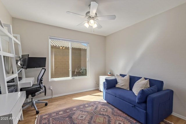office featuring baseboards, wood finished floors, and ceiling fan