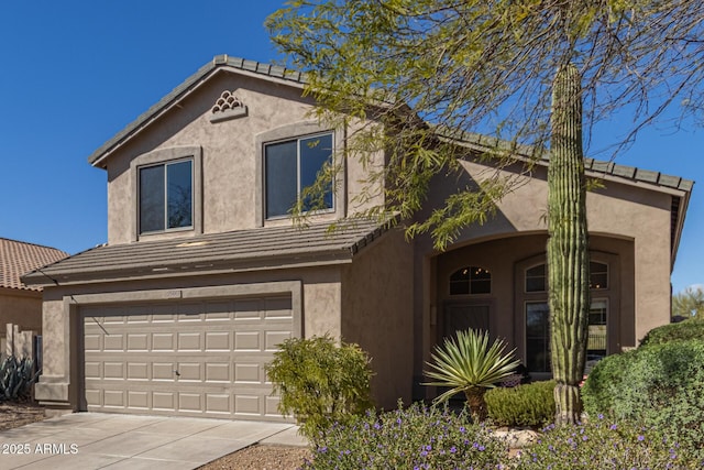 view of front facade featuring a tile roof, driveway, stucco siding, and an attached garage
