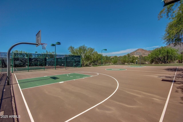 view of sport court featuring community basketball court and fence