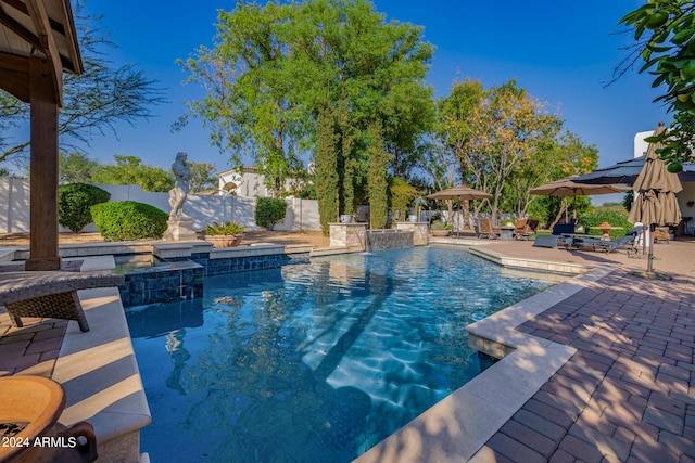 view of swimming pool featuring pool water feature and a patio area