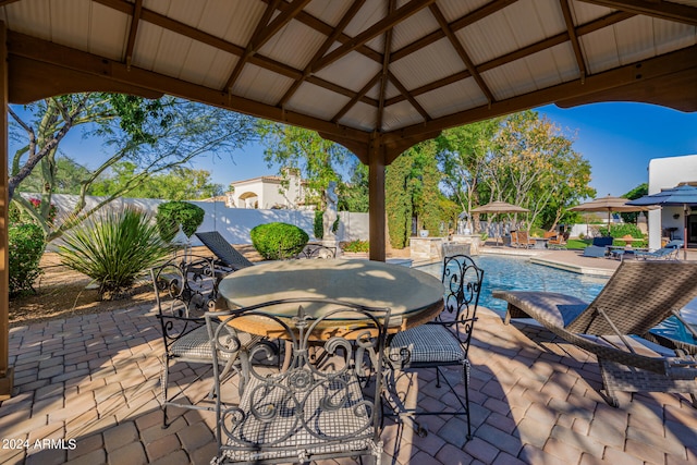 view of patio / terrace featuring a gazebo and a fenced in pool