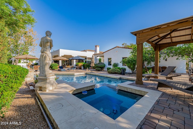 view of pool with a patio, a gazebo, and an in ground hot tub