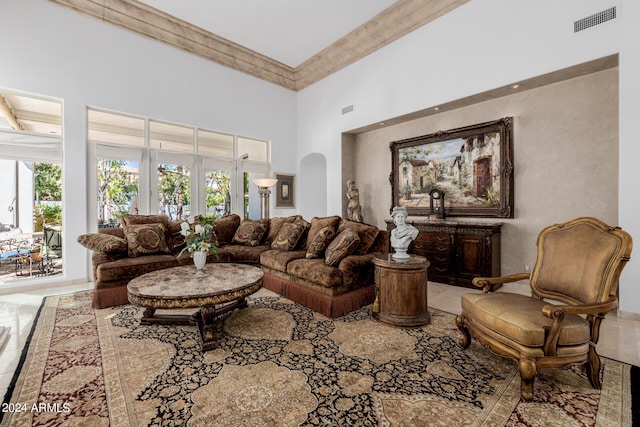 living room featuring french doors, a towering ceiling, and beam ceiling