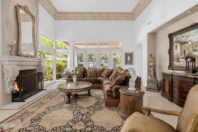 living room featuring a high ceiling and a high end fireplace