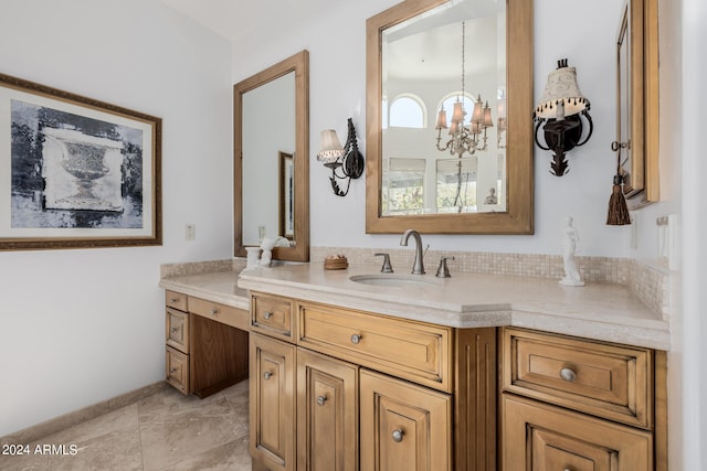 bathroom featuring a notable chandelier and vanity