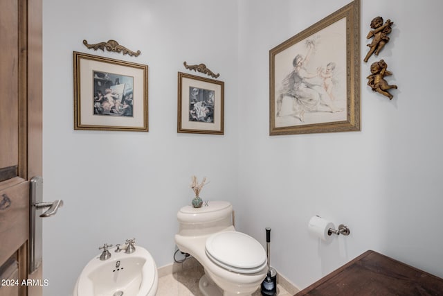 bathroom with a bidet and toilet