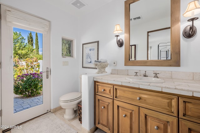 bathroom featuring tile patterned flooring, vanity, and toilet