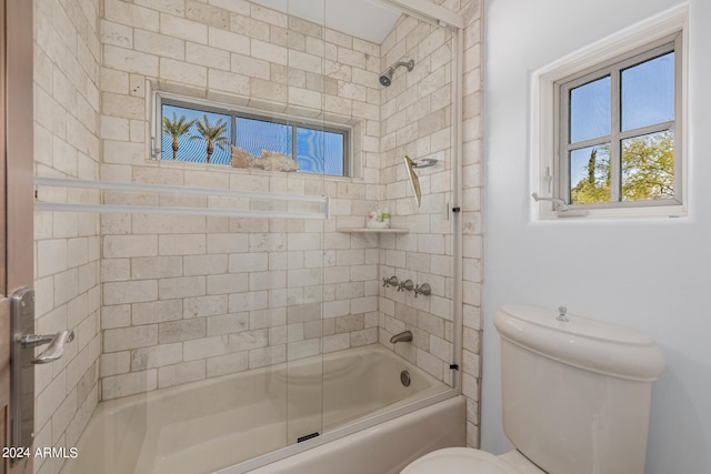 bathroom featuring tiled shower / bath combo and toilet