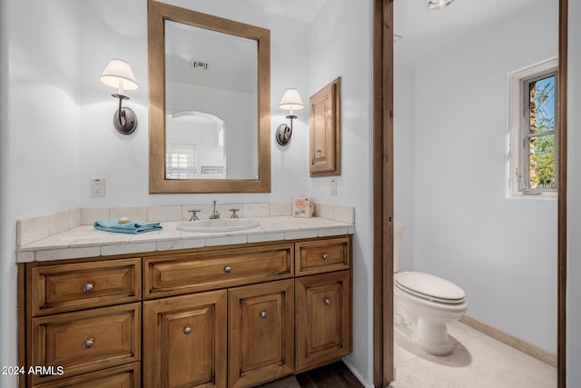 bathroom with tile patterned floors, vanity, and toilet