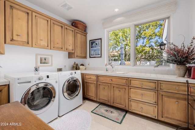 laundry area with cabinets, sink, and independent washer and dryer